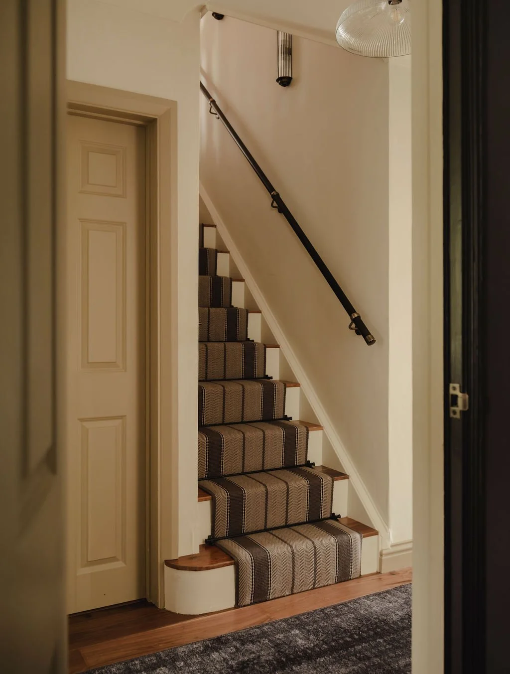 Elegant entrance hallway with runner and contrast wall paint