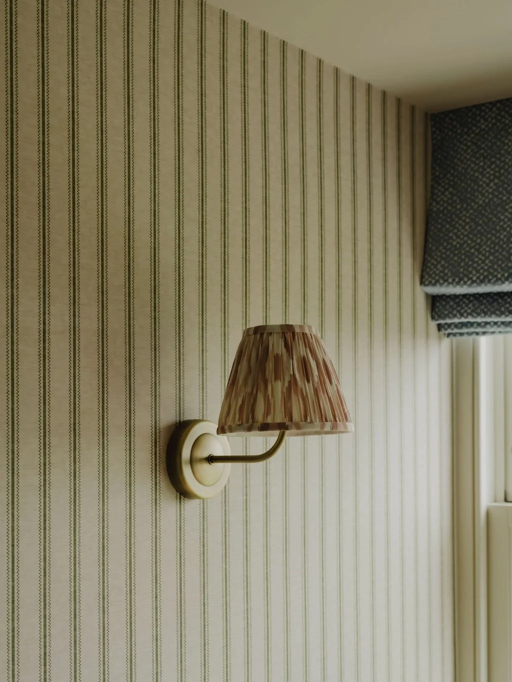 Wall-mounted bedroom light adding warmth in a Bourne End, Buckinghamshire interior
