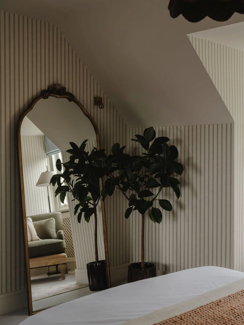 Styled bedroom corner with mirror and plant in a calm Bourne End, Buckinghamshire interior design
