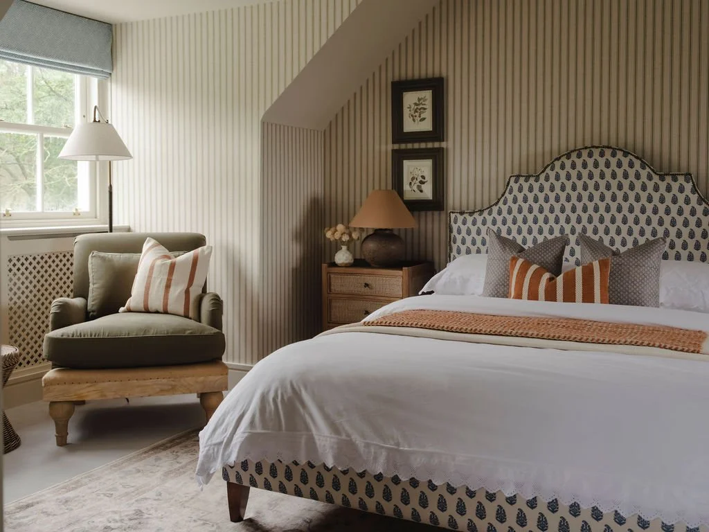 Custom upholstered bed with layered soft furnishings in a Bourne End, Buckinghamshire bedroom
