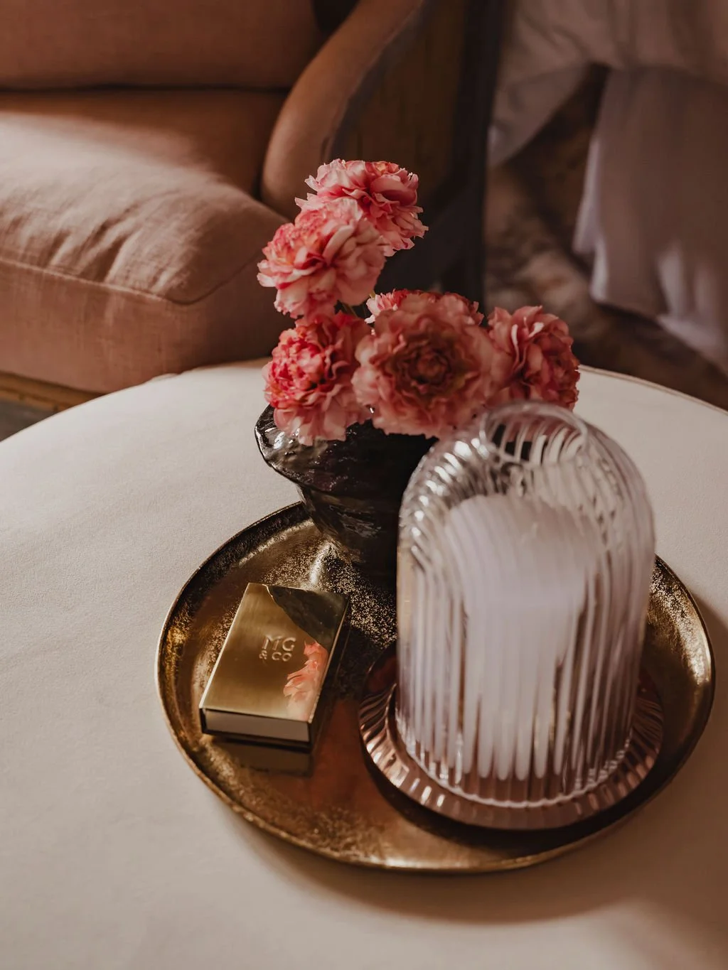 Styled tray detail on an upholstered ottoman in a boutique-style Bourne End bedroom interior
