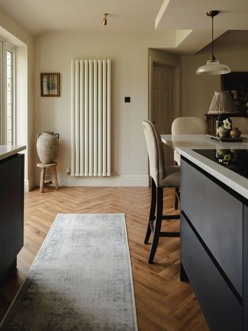 Neutral kitchen refresh with layered lighting and warm flooring