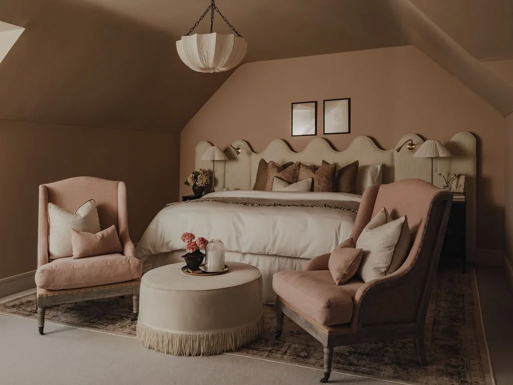 Boutique-style guest bedroom with bespoke headboard and upholstered ottoman in Bourne End, Buckinghamshire
