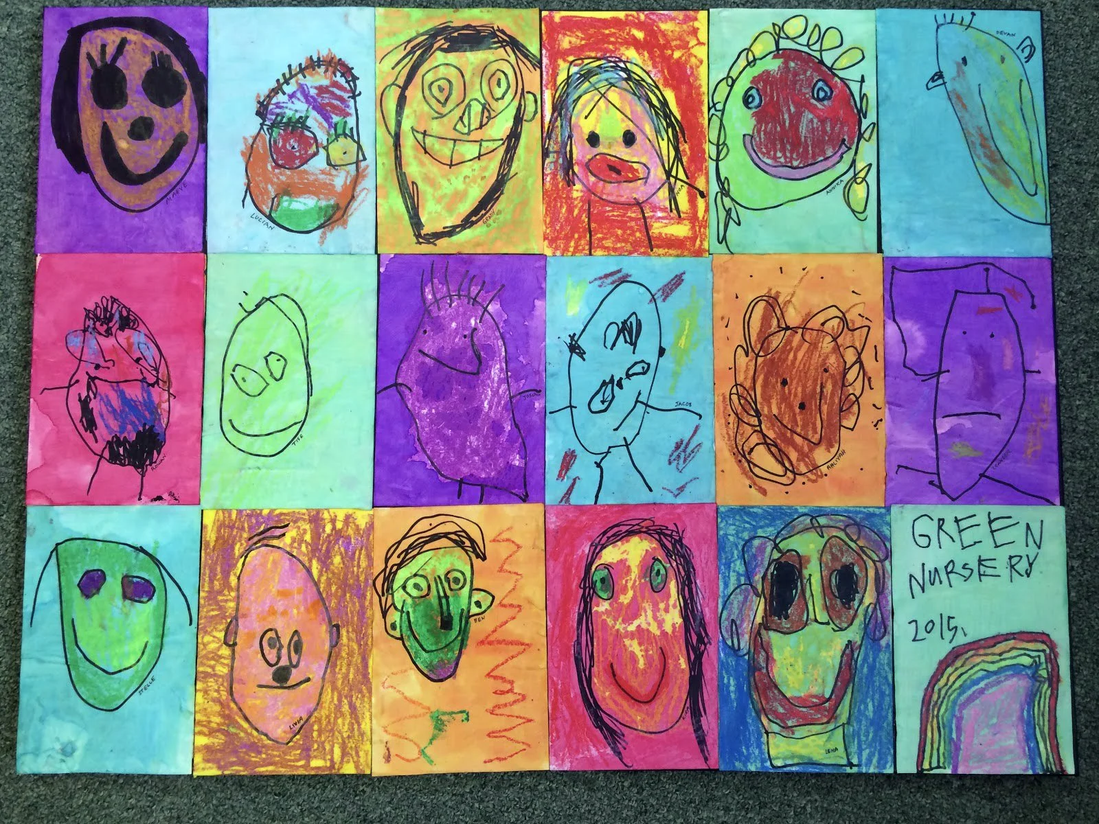 assorted craypas drawings on yellow, blue, orange, red paper of faces drawn by elementary schoolers