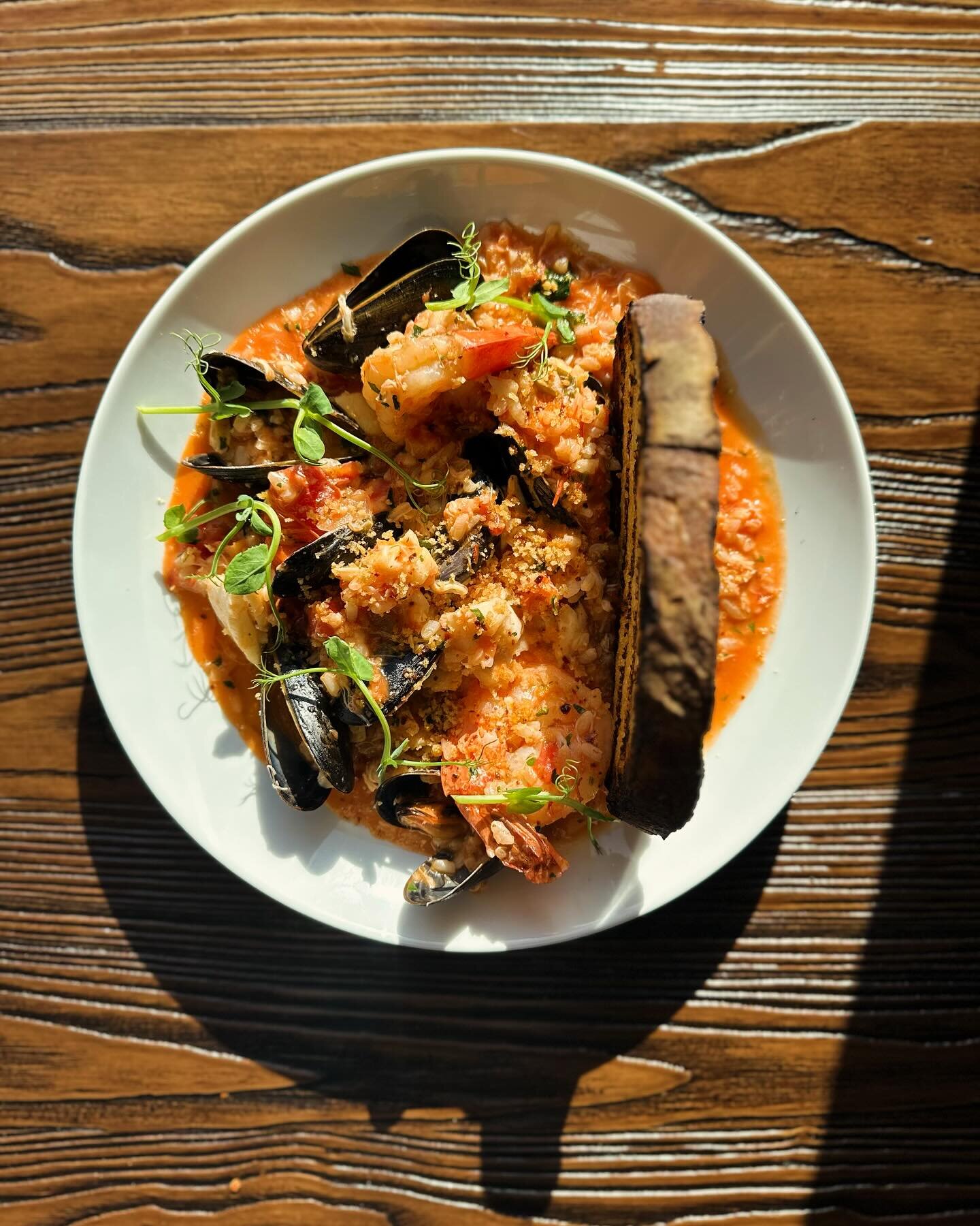 Black Sheep&rsquo;s version of Cioppino, a seafood stew where Italian fisherman would share the day&rsquo;s bounty. We use local fish stewed with Bianco tomatoes, basil &amp; mirabelli rice, a New Jersey grain similar to risotto. Finished with a piec