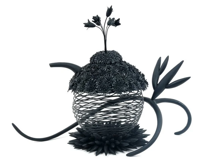 "Eve's Midnight Tea" Jeffrey Lloyd Dever 
Found Object, Inner Tube, Polymer Clay, Wire, Glass Pins 10.7" x 14" x 7.2" 
2023 
$5,000 