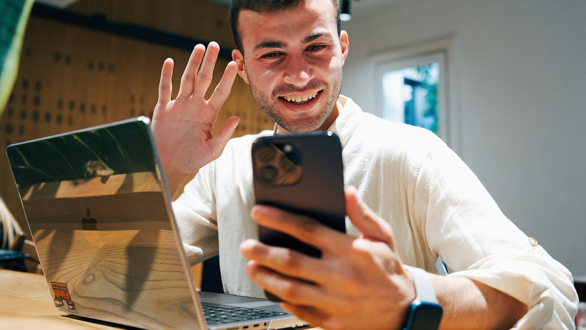 A person is taking a selfie with a smartphone while on a workshop
