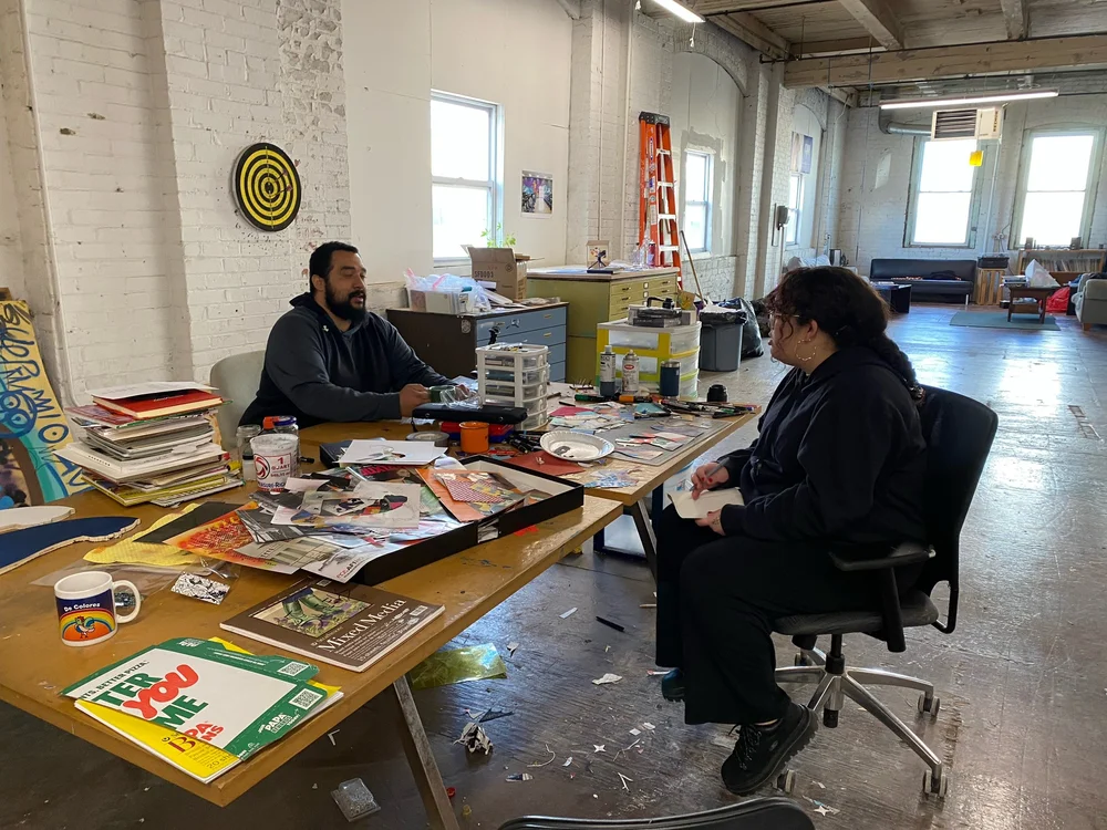 Daniels and Bayala chat in Daniels' studio