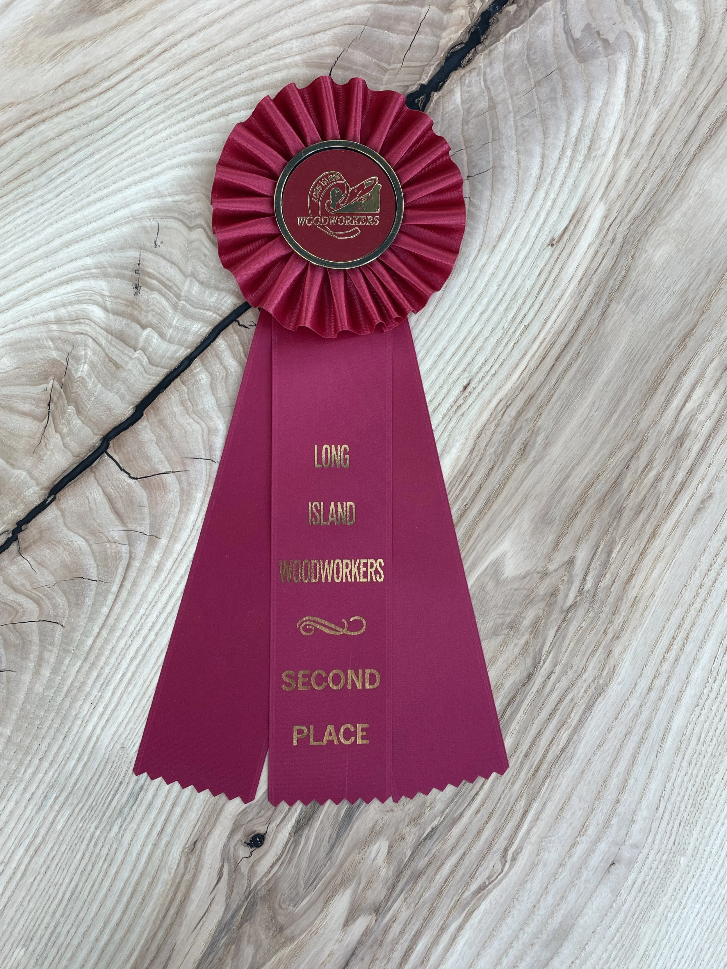 Award winning live edge side table displaying "Long Island Woodworkers Second Place" on a wooden surface for sale.