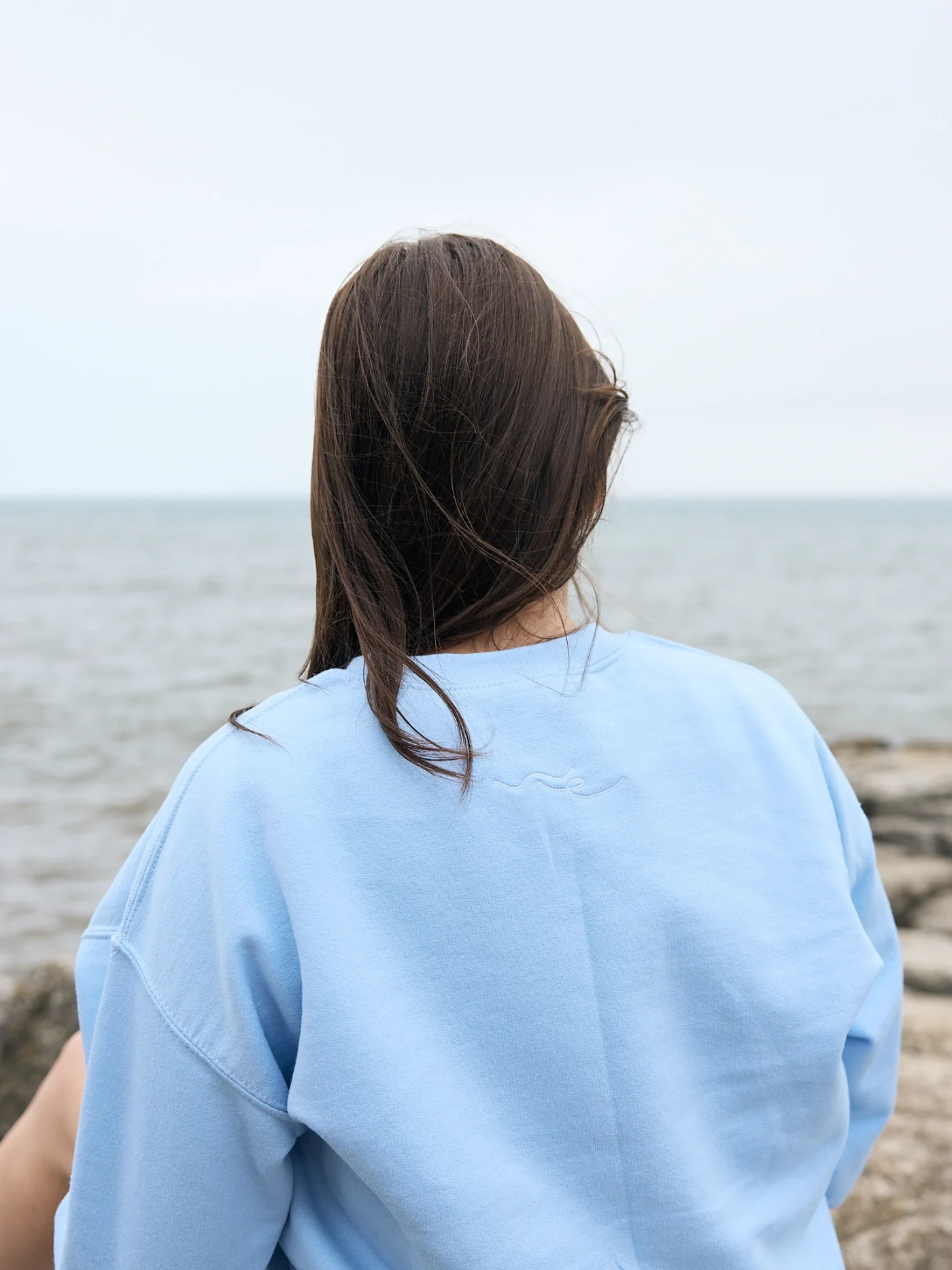 Taylor of With Ease Therapy Space in Guelph looking out at the lake.
