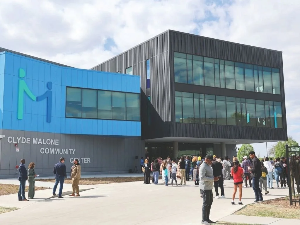 Exterior of Clyde Malone Community Center building with community members outside