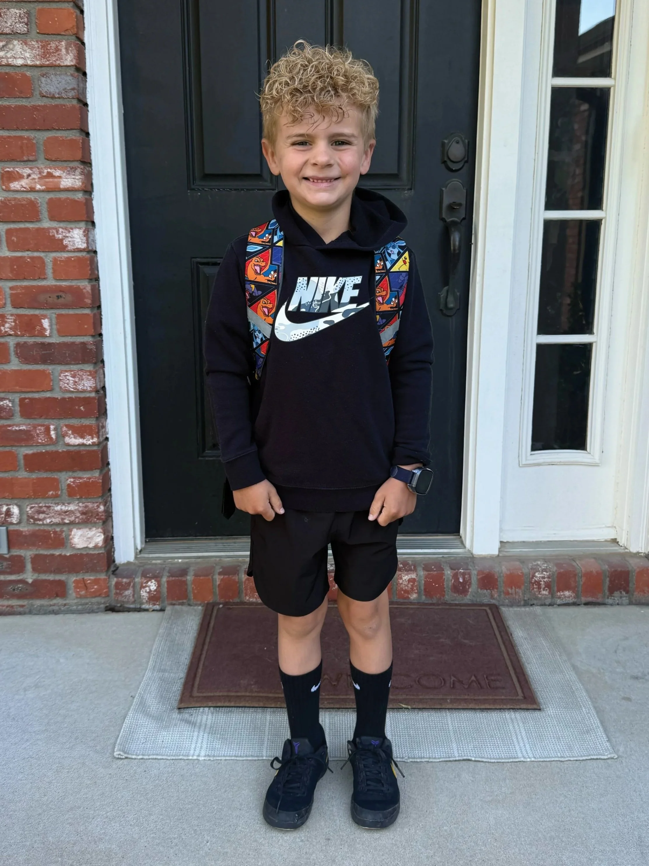 Liam standing in front of a door