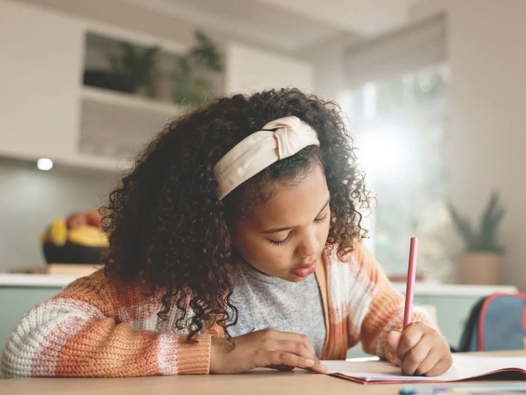 Young girl writing a limerick poem
