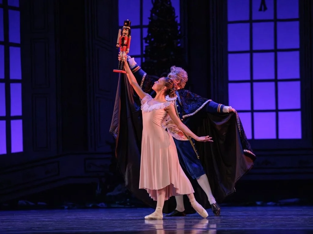 Young ballerina dressed as Clara and older male ballet dancer dressed as Drosselmeyer dancing the Nutcracker ballet