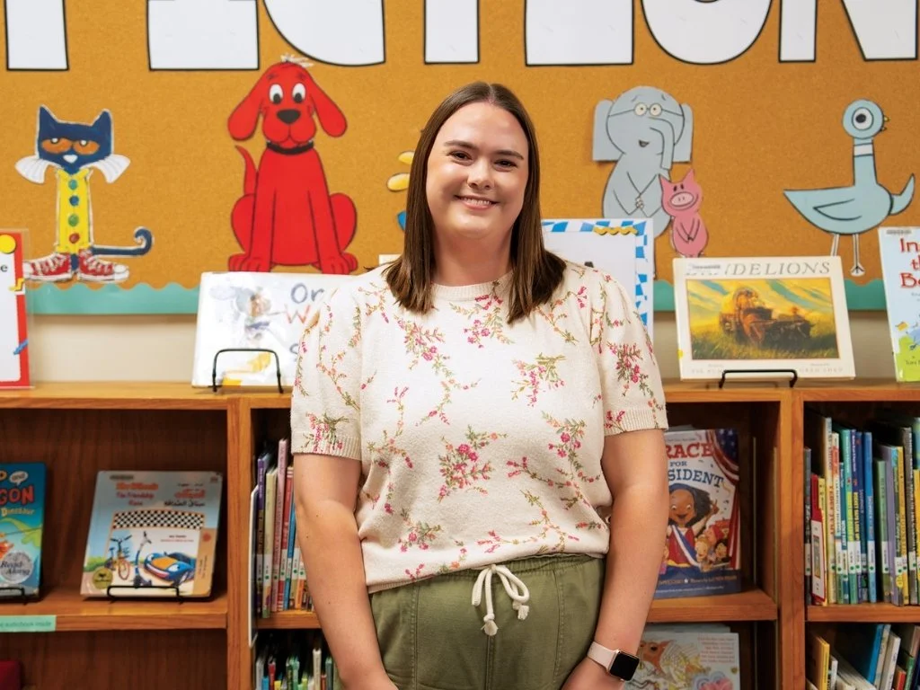 Librarian Mrs. Hoppner standing in the library at Rousseau Elementary