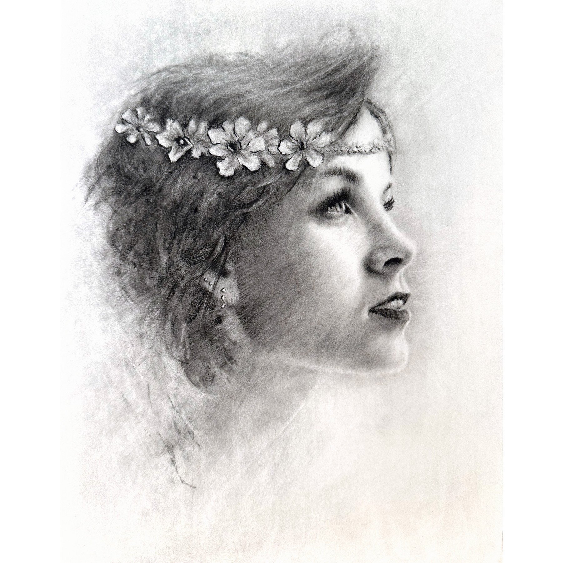 charcoal drawing portrait of a young woman with a wreath of flowers in her hair gazing off into the distance