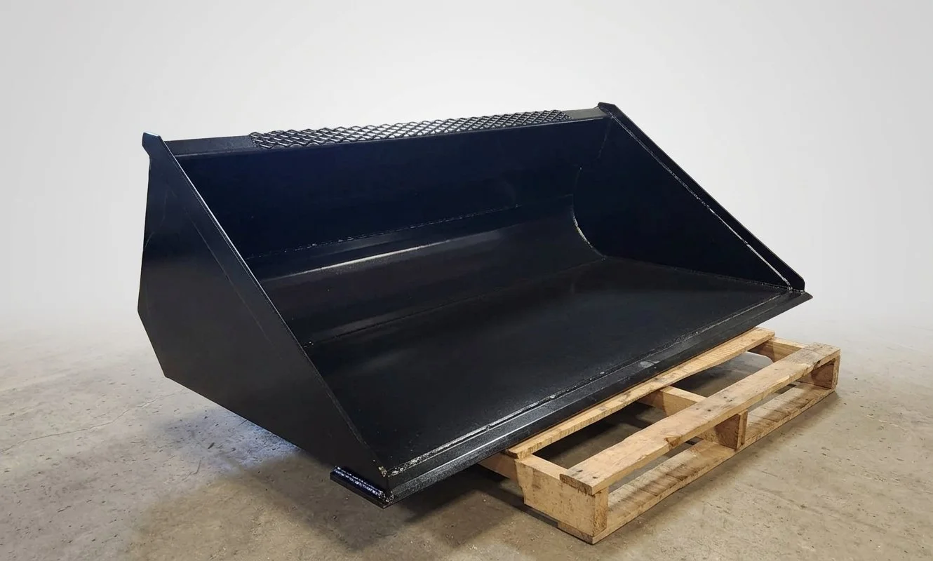 Custom heavy duty 68 inch steel skid steer dirt bucket attachment fabricated on pallet by BEP Petroleum & Tank LLC in Bismarck ND