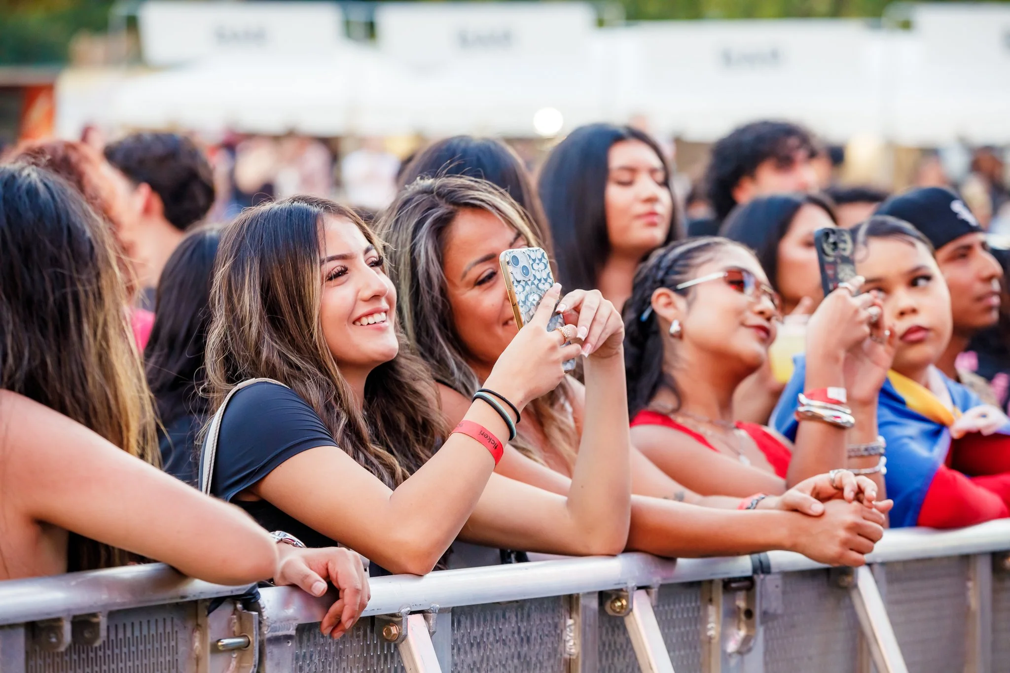 group of Latina fans enjoy the live performances at OYE Fest 2025 in Atlanta.