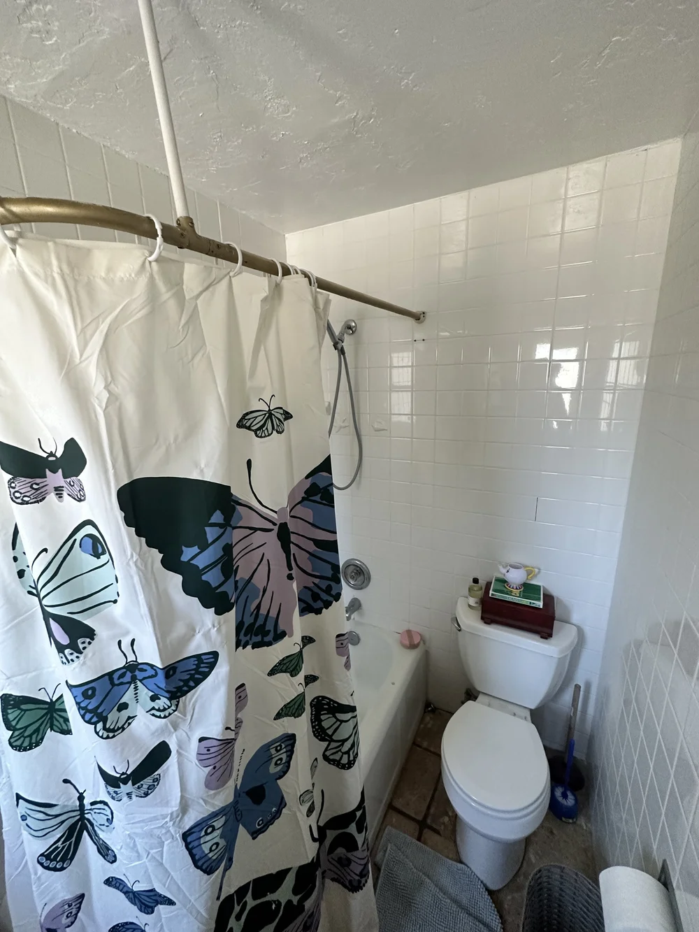 Before: Bathroom with a shower curtain at Clementine B in Oceanside