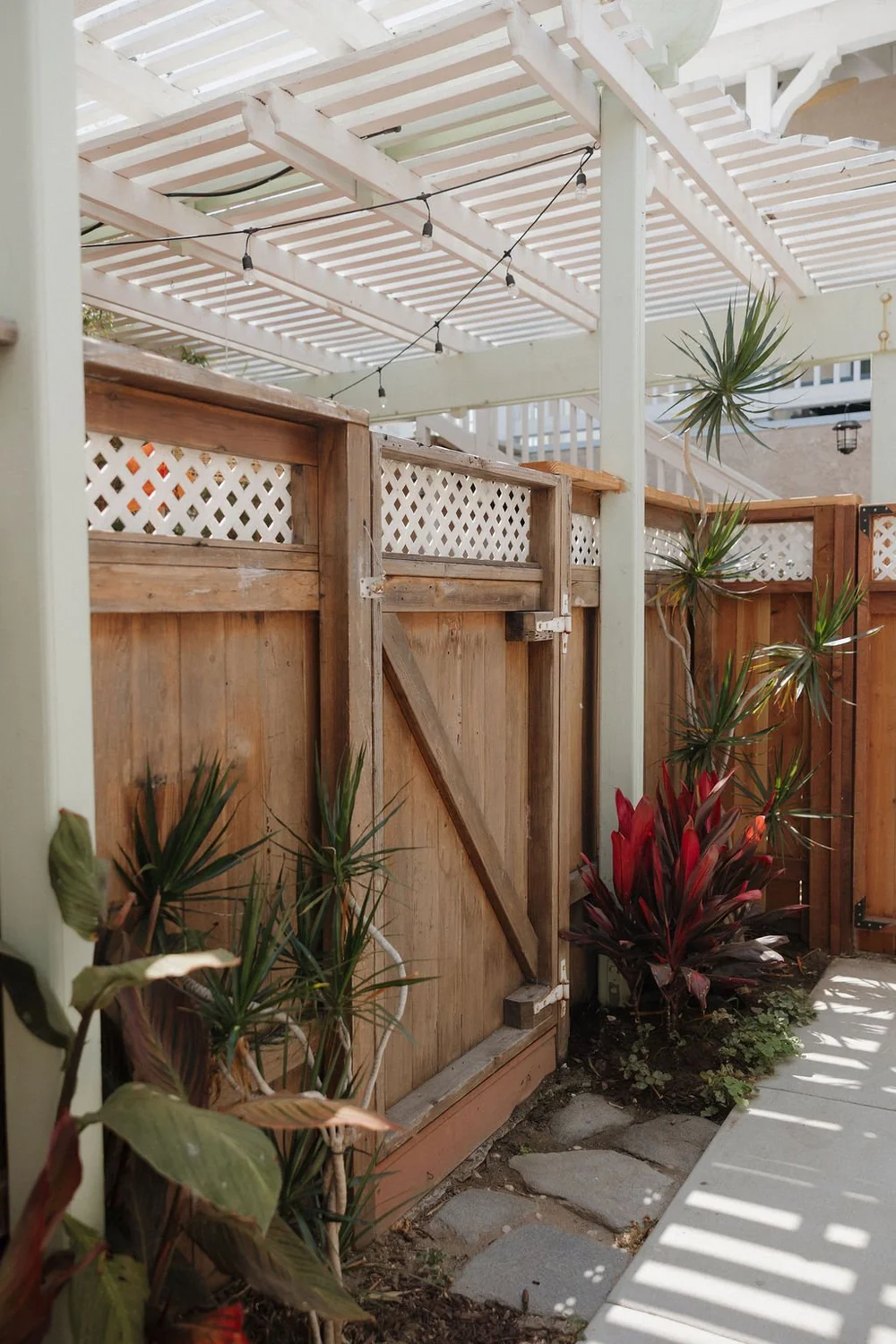 The gated garden path under the pergola outside The Sandbar studio