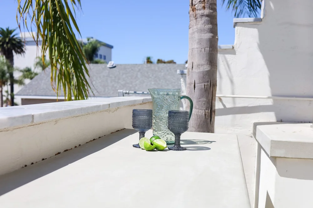 Drinks with lime slices on the patio ledge at The Swell