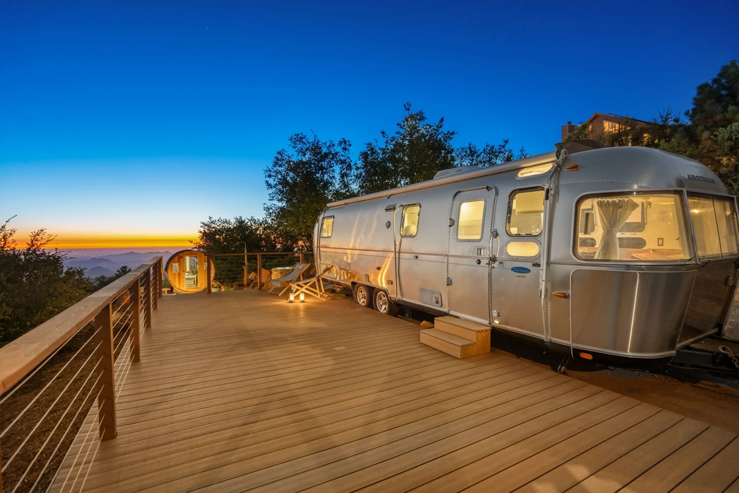 Airstream and yoga deck at Restore Outpost at sunset