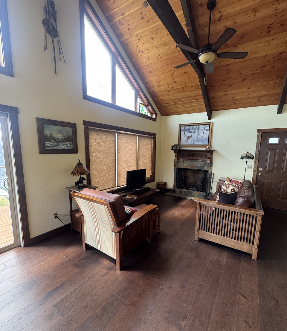 Before: living room with mission-style chairs and a fireplace