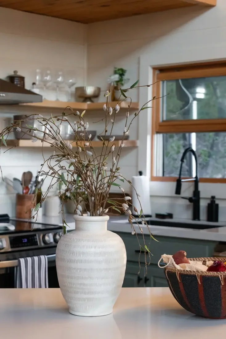 Guest photo: the kitchen counter styled with a vase of branches