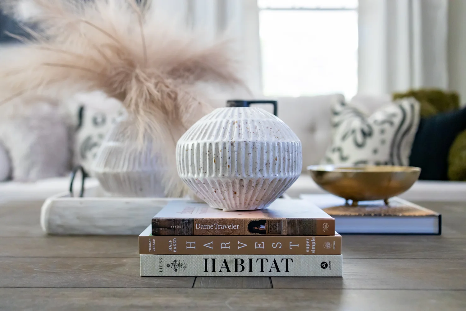 Coffee table styling with pampas grass, a white vase and books at Elmsgate in Birmingham, designed by Salt and Sky Lodging Co.