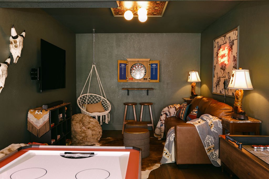 Game room with a hanging chair, air hockey table and bar stools