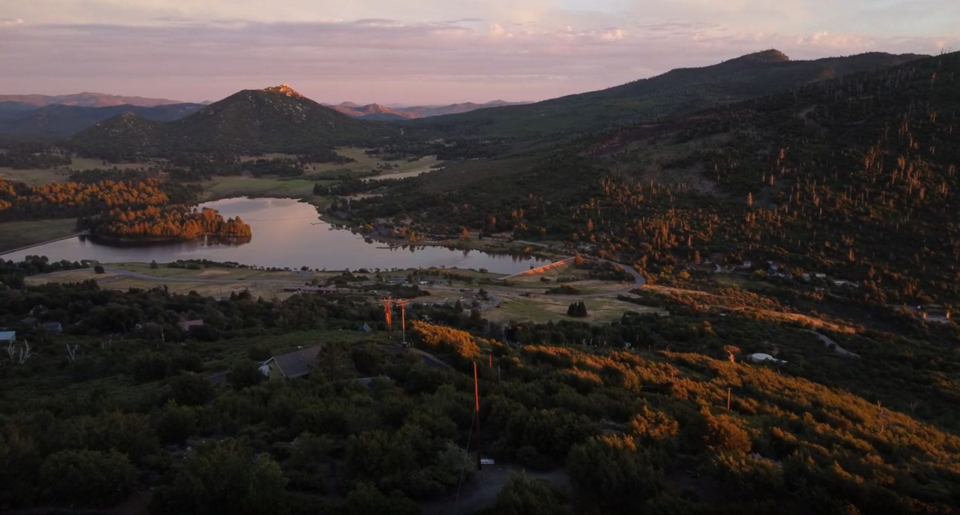 Aerial view of Lake Cuyamaca surrounded by mountains near Julian, CA at sunset