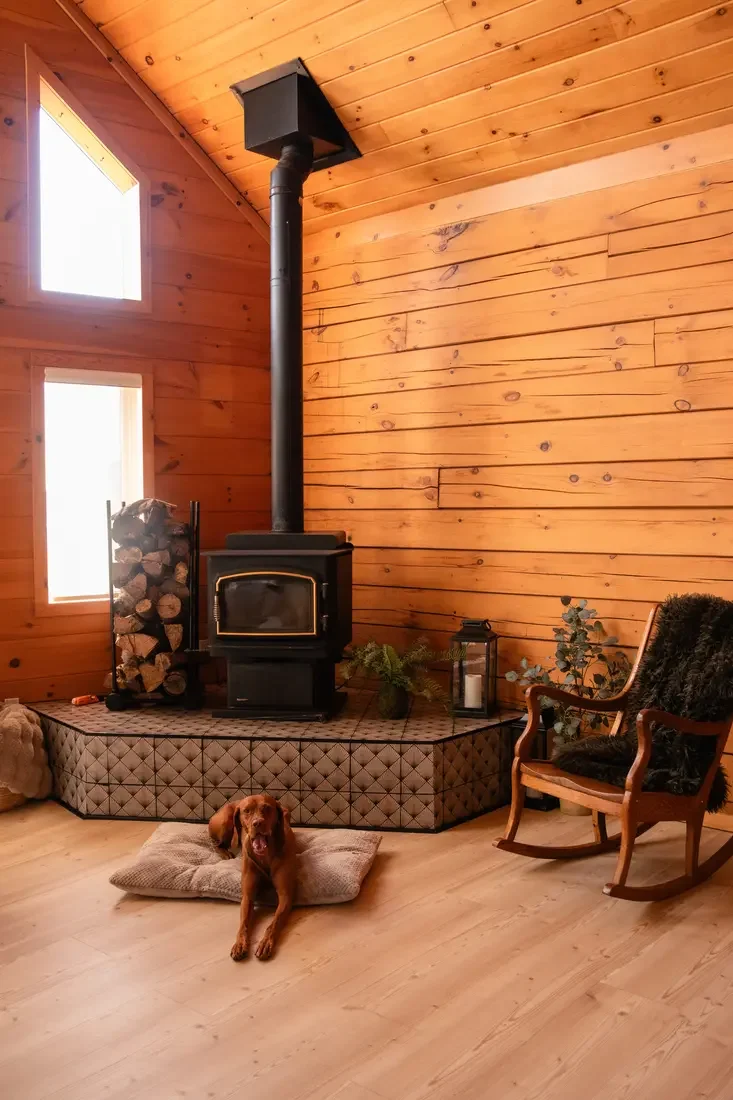 Guest photo: the wood-burning stove and rocking chair with the dog resting nearby
