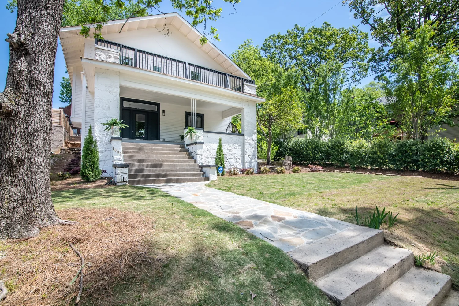 The 1910 craftsman home from the front walk at Elmsgate in Birmingham, designed by Salt and Sky Lodging Co.