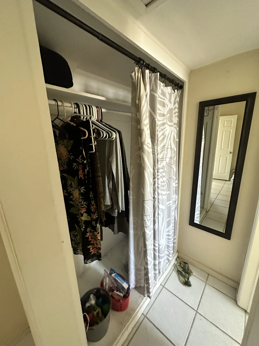 Before: Closet with clothes and a mirror at Clementine A in Oceanside