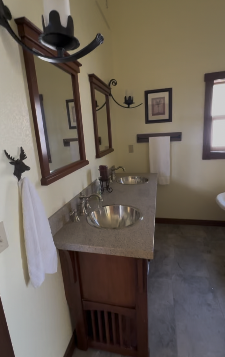 Before: bathroom with a pedestal vessel sink and mirror