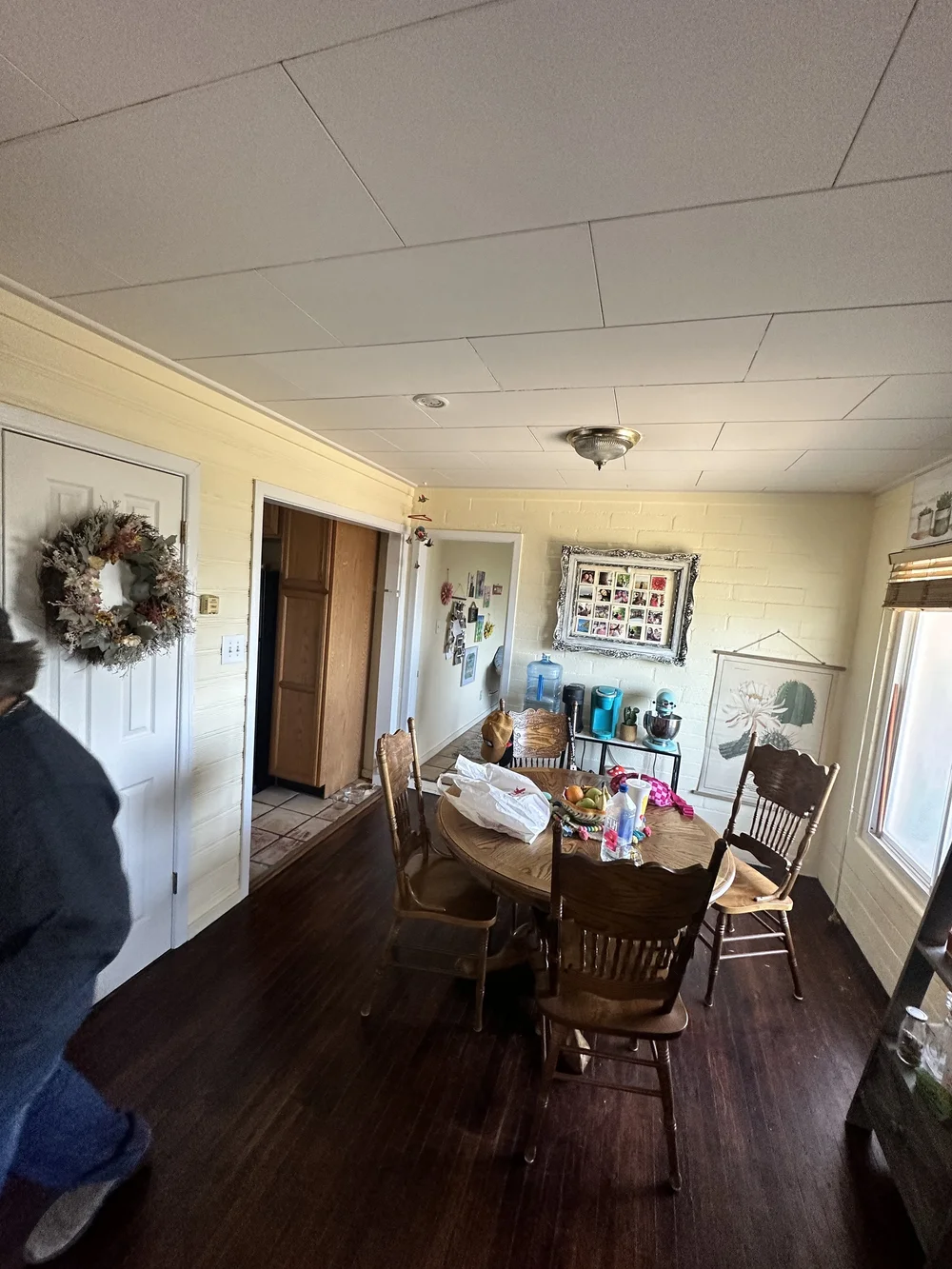 Before: Dining room with a wreath on the door at Clementine B in Oceanside