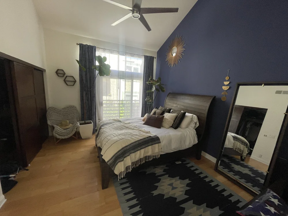 Before: Bedroom with a navy accent wall at Velvet Surf in Pacific Beach