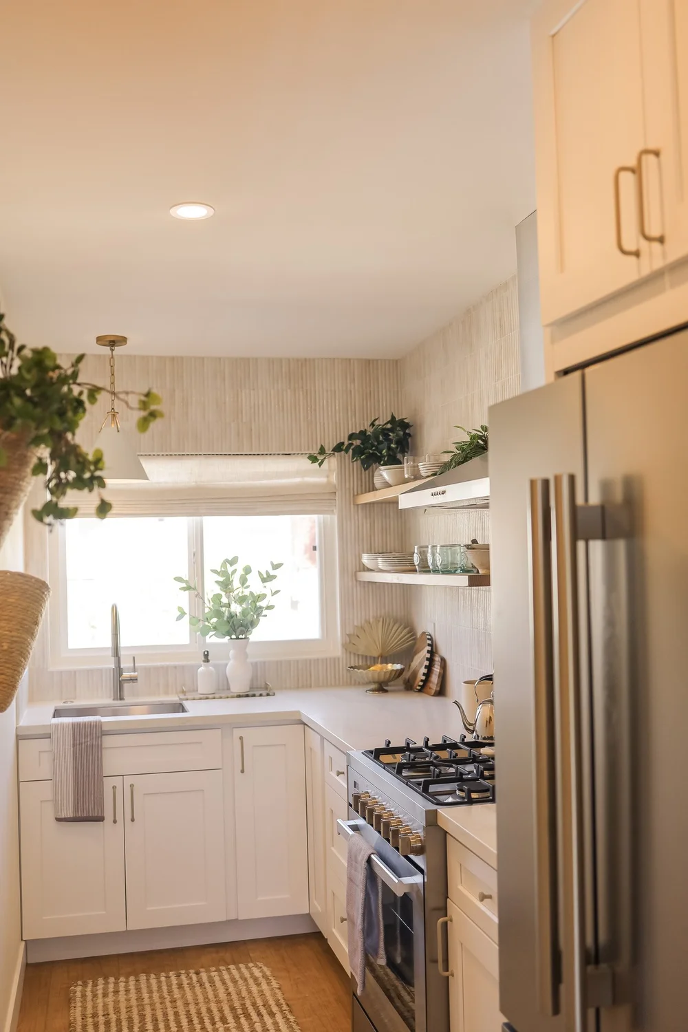The kitchen with a gas range and open shelves in Unit Three at The Swell, Oceanside