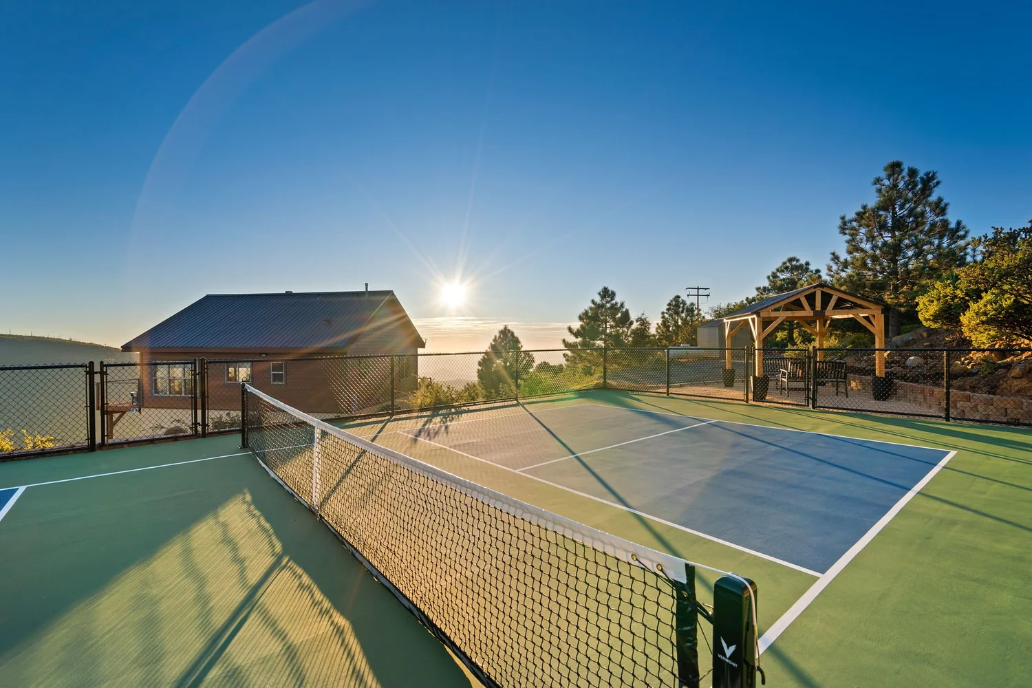 Private pickleball court at sunrise with mountain views