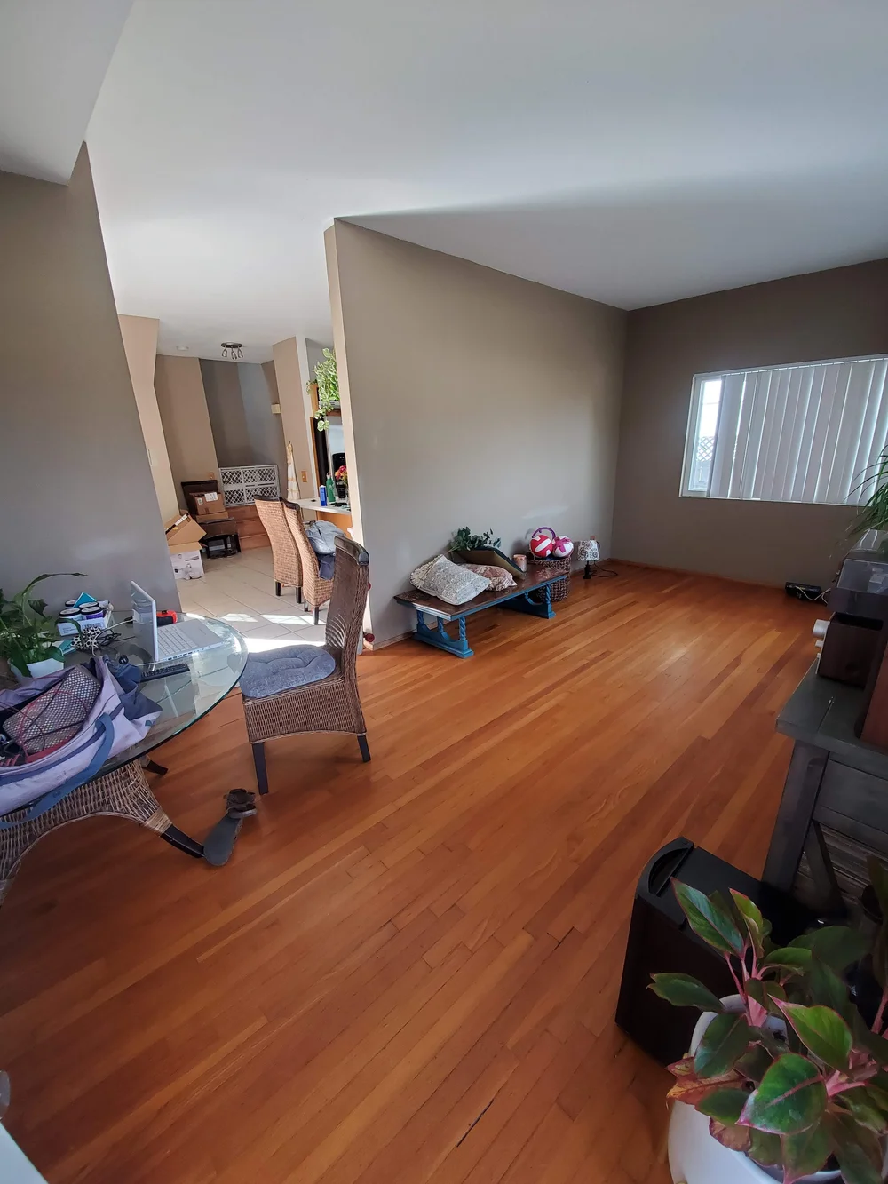 Before: Living room with wood floors at OB Surfer's Paradise in Ocean Beach