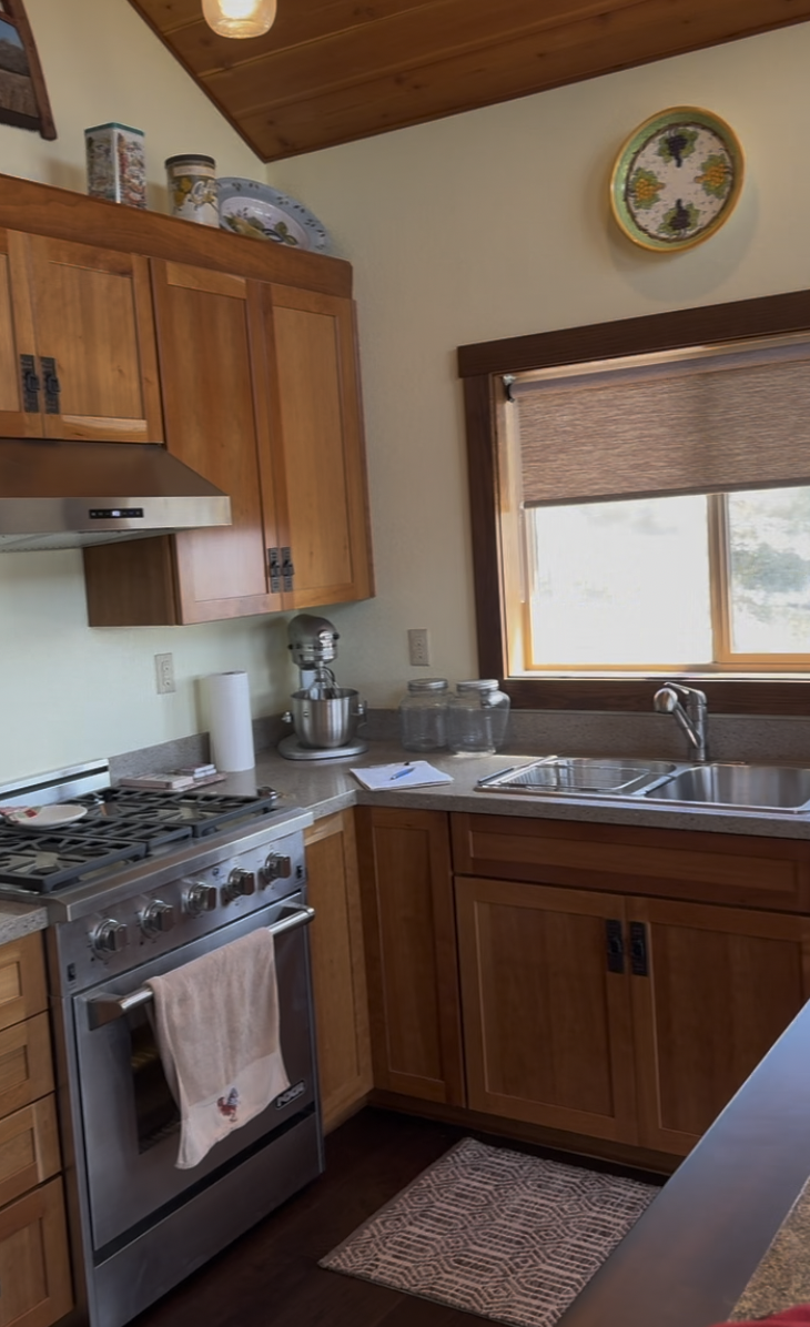 Before: kitchen corner with oak cabinets and a gas range
