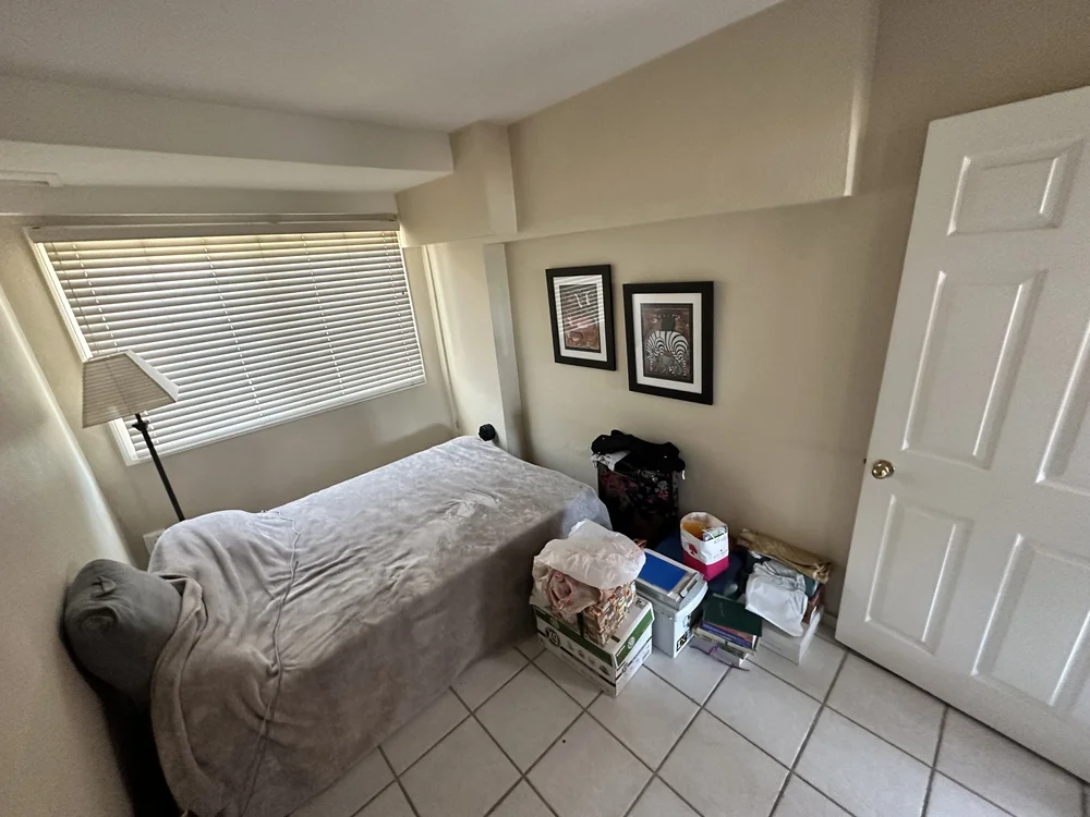 Before: Bedroom with a tile floor at Clementine A in Oceanside