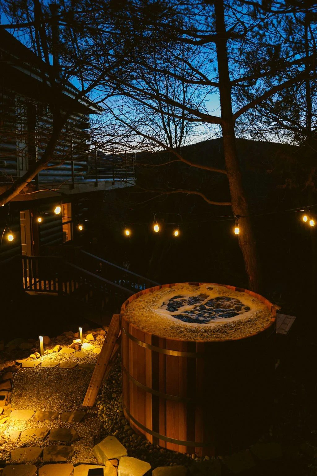 The cedar hot tub at Dark Moon Chalet after dark