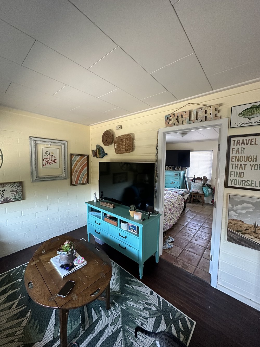 Before: Living room with a teal TV stand at Clementine B in Oceanside