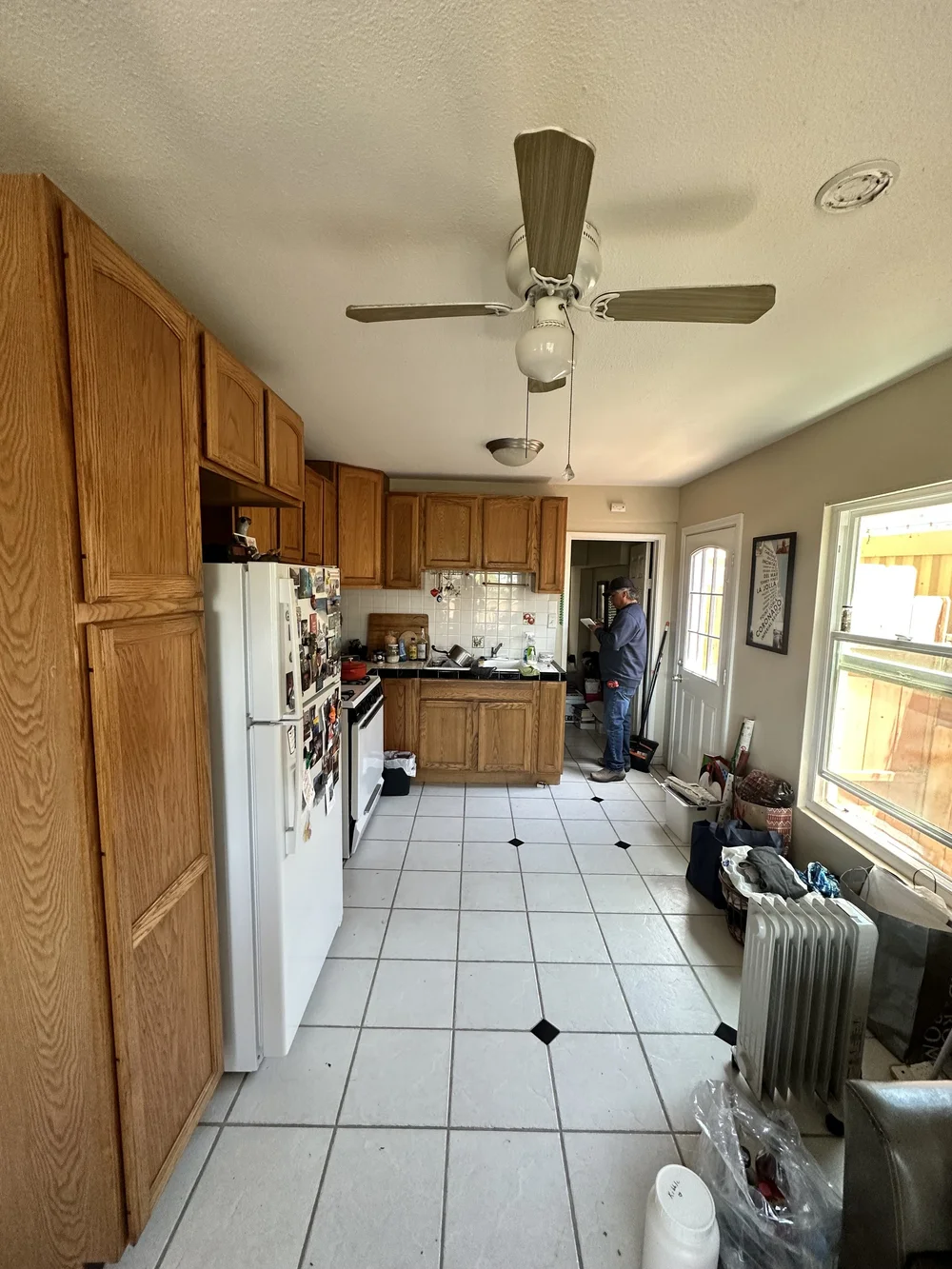 Before: Kitchen with oak cabinets and a tile floor at Clementine A in Oceanside