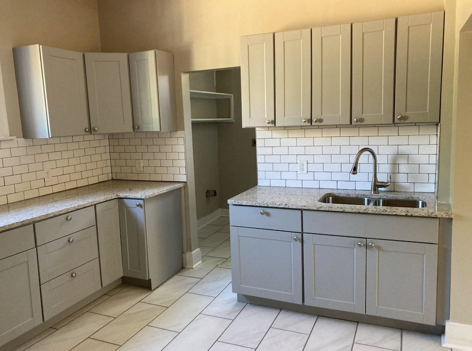 Before: Kitchen with gray cabinets and subway tile at Elmsgate in Birmingham