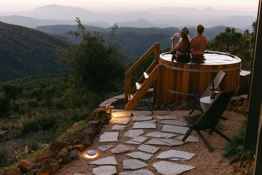 Stone path and steps up to the cedar hot tub deck with mountain views