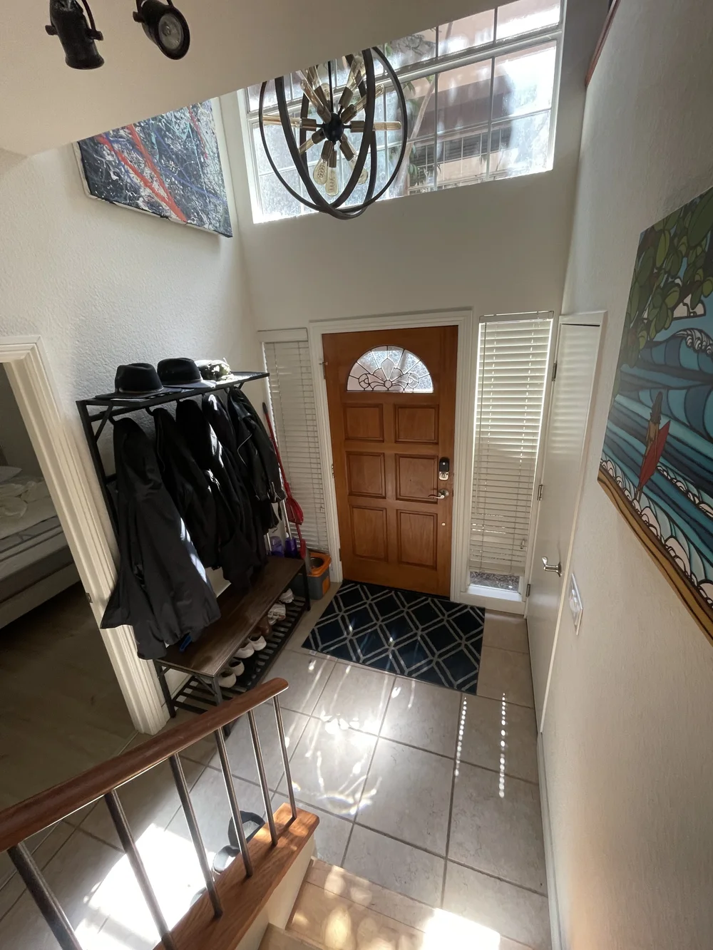 Before: Entry with a tile floor and stairs at Velvet Surf in Pacific Beach