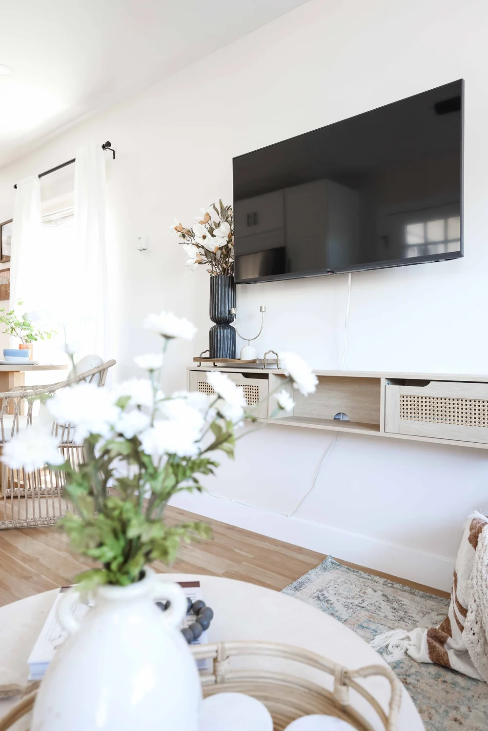 Fresh flowers and the living room TV in Unit Two at The Swell, Oceanside