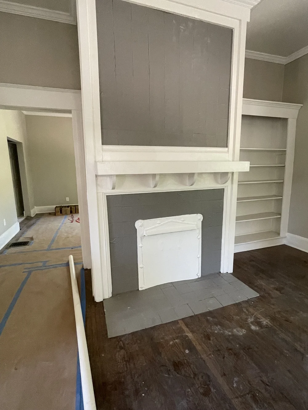 Before: Living room with an unfinished fireplace during the remodel at Elmsgate in Birmingham